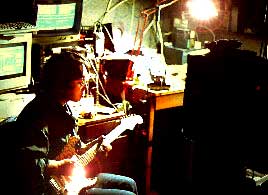 Tada with guitar in his shack